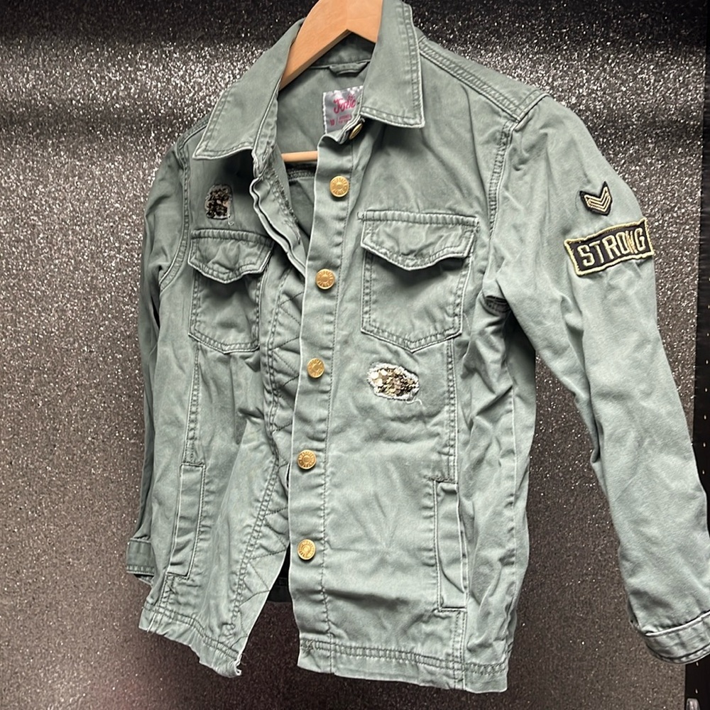 Justice Girls Size 10 green denim jacket with ‘strong’ patch on left sleeve
